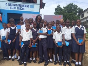 Group Head, Marketing and Corporate Communications, United Bank for Africa( UBA) Bola Atta flanked by pupils of C. William Brumskine elementary school, Monrovia, during a visit to the school as part of UBA foundations Read Africa, Initiative