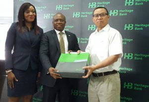 Mrs. Adaeze Udensi, Executive Director; Retail & SME Bank; Jude Monye, Executive Director Business Banking; who both represented the MD/CEO of Heritage Bank Plc, Ifie Sekibo; presenting a gift to the General Manager, Biase Plantations Limited (BPL), Mr. Ahmad Mustaffa Goh, at the signing ceremony of N232million Pilot Out-growers’ Agreement between the Bank and BPL at Heritage Bank’s Head Office, Lagos.