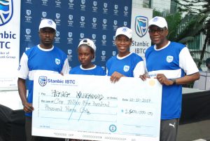 Chief Executive, Stanbic IBTC Holdings Plc, Mr. Yinka Sanni; Non-Executive Director, Stanbic IBTC Holdings Plc, Mrs. Ngozi Edozien; a beneficiary prosthetic limbs & education trust  donated by Stanbic IBTC, Hawa Mohammed; Father of the beneficiary, Mr. Mohammed during the presentation of cheques to beneficiaries of Stanbic IBTC 2017 “Together For A Limb” CSI Initiative in Lagos, on Saturday, 28 Oct, 2017