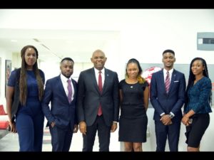 Chairman United Bank for Africa and Heirs Holdings, flanked by young hires at Heirs Place