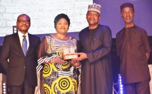 L-R: Group Managing Director, Dangote Industries Limited, Olakunle Alake; Best National Distributor of Dangote Cement, Mrs. Beatrice Okika, MD, D. C. Okika Nig. Ltd., receiving an award from President/CE, Dangote Industries Limited, Aliko Dangote; and Group Managing Director, Dangote Cement Plc, Engr. Joseph Makoju at the Dangote Cement Plc 2018 Distributors Award Night, in Lagos on Monday, March 4, 2019