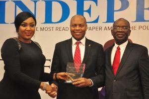 Pix 1, l-r: Director, Independent Newspapers, Adaobi Nwakuche, presenting the award of the  Most Innovative Bank won by UBA Plc  to the Divisional Head, Digital and Consumer Banking, United Bank for Africa( UBA) Plc, Mr Yinka Adedeji while Managing Director, Independent Newspapers, Mr. Ted Iwere looks on,  at the Independent Newspapers Awards,  held  in Lagos at weekend