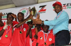 Group Zonal Head, Akwa Ibom, Zenith Bank Plc, Mr. Asuquo Ita, presenting the U-13 trophy to the South-West Team