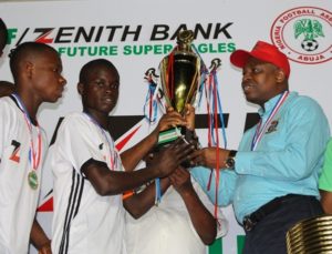 Group Zonal Head, Akwa Ibom, Zenith Bank Plc, Mr. Asuquo Ita,presenting the U-15 trophy to the South-South Team