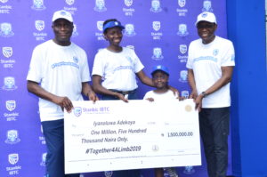 L-R: Dr. Adeyemi Omobowale, Chief Executive Officer, Reddington Hospital Group; Mrs. Ruth Adekoya, mother of the beneficiary; Iyanuoluwa Adekoya, Together4ALimb 2019 beneficiary and Yinka Sanni, Chief Executive, Stanbic IBTC Holdings PLC; during the presentation of EduTrust funds to beneficiaries at the 2019 edition of the Together4alimb Walk, organized by Stanbic IBTC Holdings, on Saturday, November 9.
